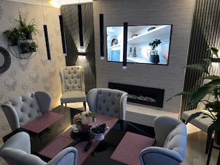 Renoviertes Wohnzimmer mit Sesseln und TV-Wand